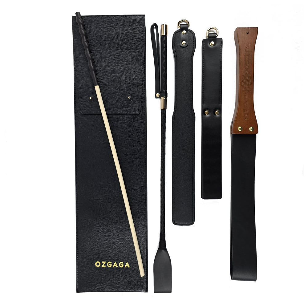 Deluxe BDSM Punisher Spanking Kit featuring impact play tools including a riding crop, spanking cane, leather paddle ruler, triple-layered spanking paddle, and a wooden-handle leather paddle, displayed with a black leather storage bag.