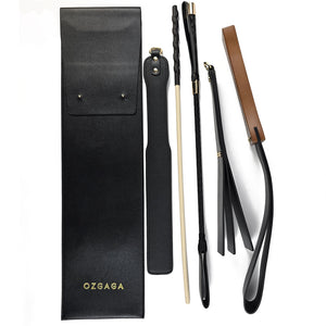 Deluxe BDSM Punisher Spanking Kit featuring impact play tools including a riding crop, spanking cane, leather paddle ruler, triple-layered spanking paddle, and a wooden-handle leather paddle, displayed with a black leather storage bag.