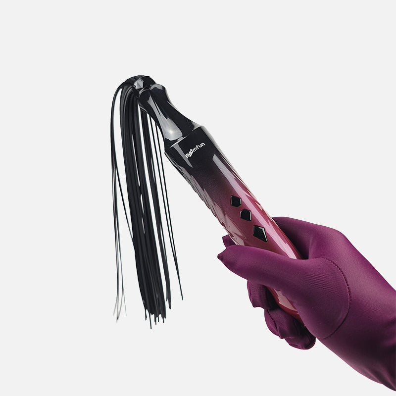 An electric whip and glass wand 2-in-1 interchangeable electro play e-stim set, featuring a metallic pink-to-black gradient handle with a long black tassel, shown on a light gray background with text at the top.