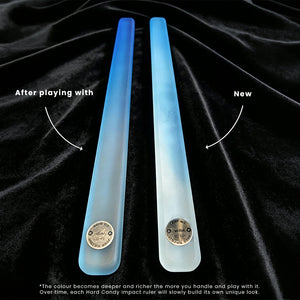 Two translucent blue hard candy impact rulers on a black velvet background, with text overlays comparing the 'After playing with' and 'New' states, showing a color-changing gradient effect.