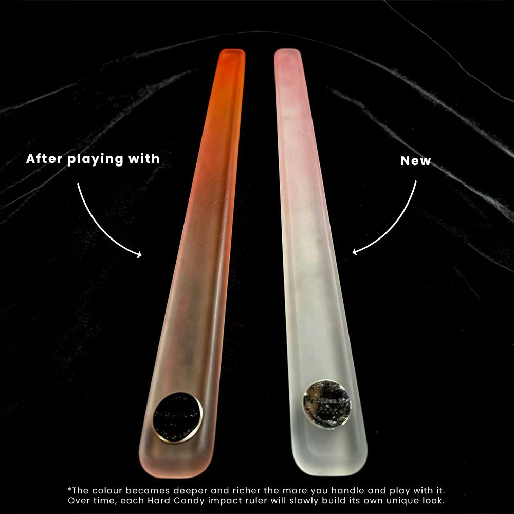 Two Hard Candy impact rulers on a black background, labeled 'After playing with' on the left and 'New' on the right, showing a color-changing translucent finish that deepens with use.