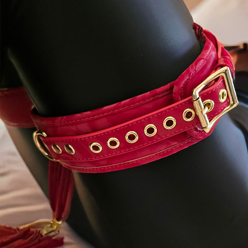 Red leather belt with gold hardware on a black background. OZGAGA Deluxe Red Passion Velvet Bondage Restraint Spanking Kit (15pc)