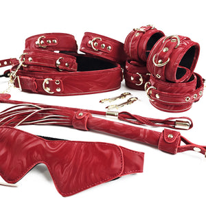 Red leather bondage set with gold hardware on a white background. OZGAGA Deluxe Red Passion Velvet Bondage Restraint Spanking Kit (15pc)