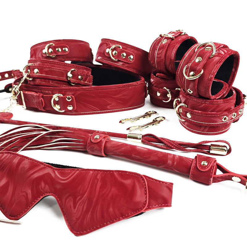 Red leather bondage set with gold hardware on a white background. OZGAGA Deluxe Red Passion Velvet Bondage Restraint Spanking Kit (15pc)