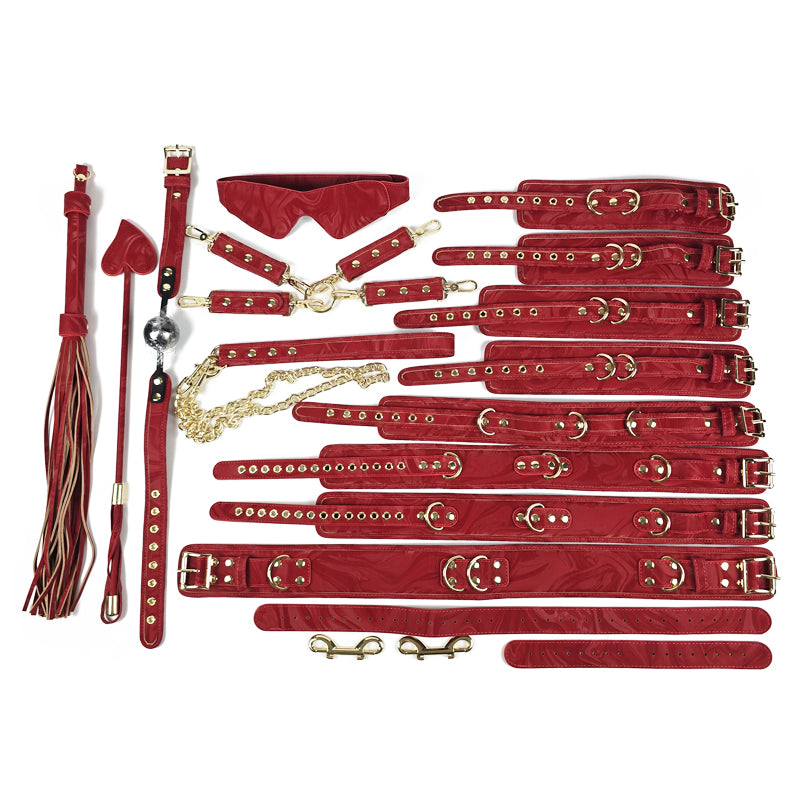 Collection of red leather bondage accessories on a white background. OZGAGA Deluxe Red Passion Velvet Bondage Restraint Spanking Kit (15pc)