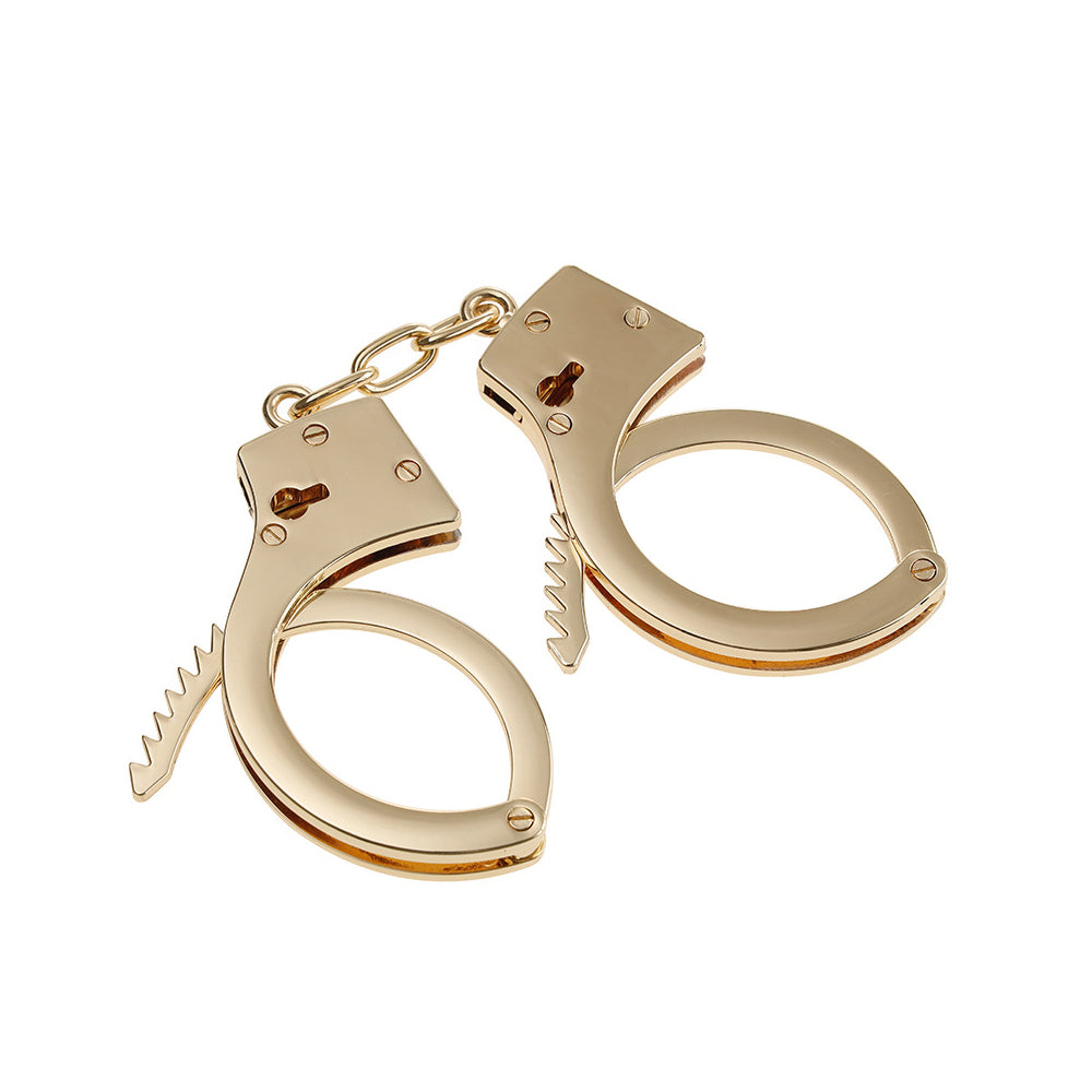 Gold stainless steel handcuffs with safety release and keys, designed for BDSM play, featuring a sleek and durable design.